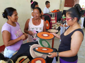 Artisans practice selling crafts to tourists