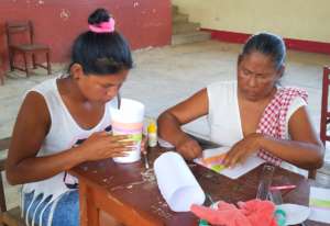 Artisan group making model of bottle carrier