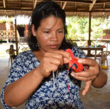 Mirian making cardinal bird ornament at Nauta