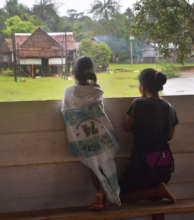 Mother and daughter looking at rain in Nuevo Peru