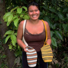 Nuevo Peru artisan with two bottle carrier models