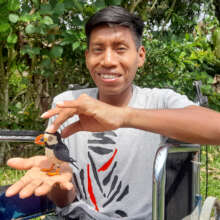 Huitoto artisan Nicolas with puffin ornament