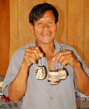 Bora artisan with etched calabash pod ornaments