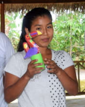 Artisan showing toucan made by her group