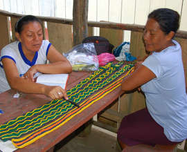 CACE manager Yully reviewing crafts with Angelina