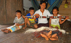 Bora artisan with woven guitar strap and children
