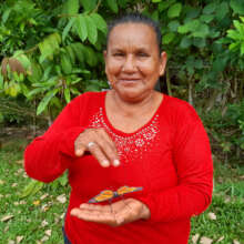 Bora artisan Zafira with woven monarch butterfly