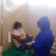 Health post technician treating COVID patient
