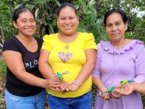 Three artisans with chambira dragonfly ornaments