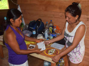 CACE paying artisan for handicraft on delivery