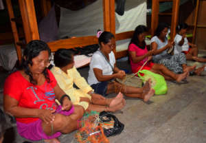 Artisans twining chambira fiber at CACE workshop