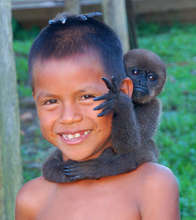 Bora boy with baby monkey on his head
