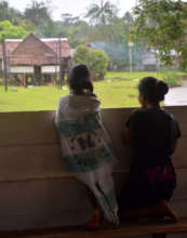 Mother and daughter looking at rain at Nuevo Peru