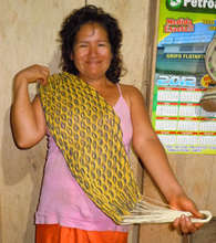 Yagua woman artisan with palm fiber doll hammock