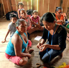 Native artisans learning to make woven butterflies