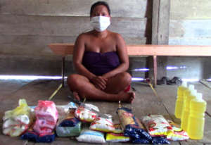 Bora woman with CACE relief supplies