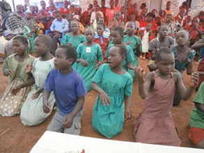Children performing during school visit in August