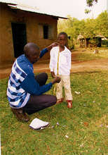 Boy being measured for a new uniform