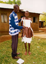 Girl measured for new school uniform