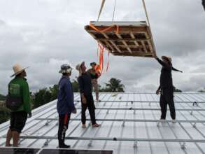 The team on top gently guide in the cradle