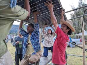 Shambhala volunteers help install solar panels