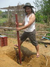 Seya Paul digs solar panel support post