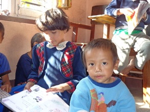 Small kids reading at the orphanage