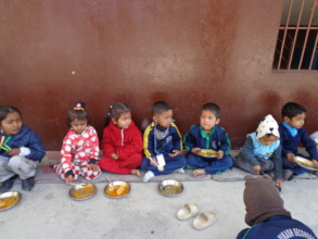 Children having food provided by CDC Nepal