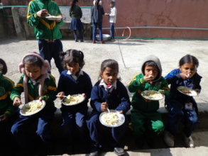 Children having food provided by CDC Nepal