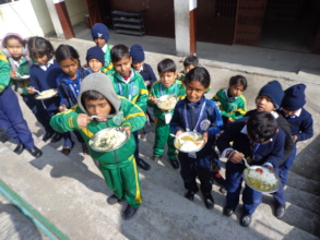 Children having food provided by CDC Nepal