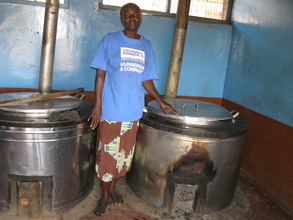 One of the cooks and the cooking vessels