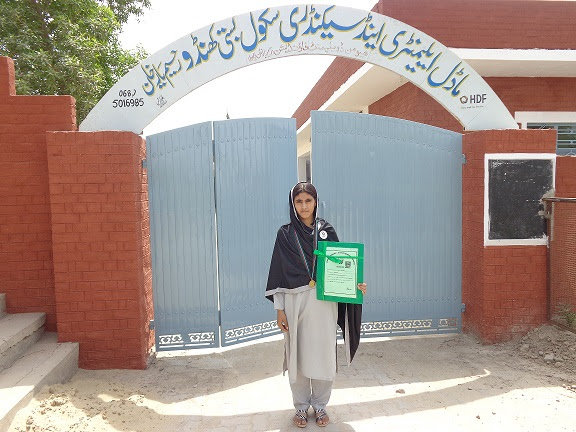 Aqsa in front of her school