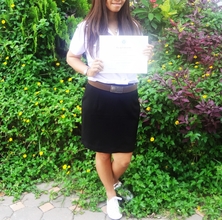 Tai Holding Her FirstClassHonors Certificate