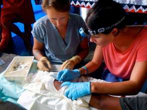 Dr's Elle Lee and Kim stitch up a machete wound