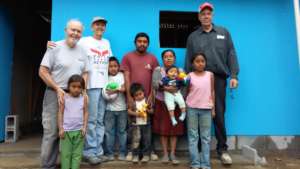 The family, service team members, and the NEW HOME