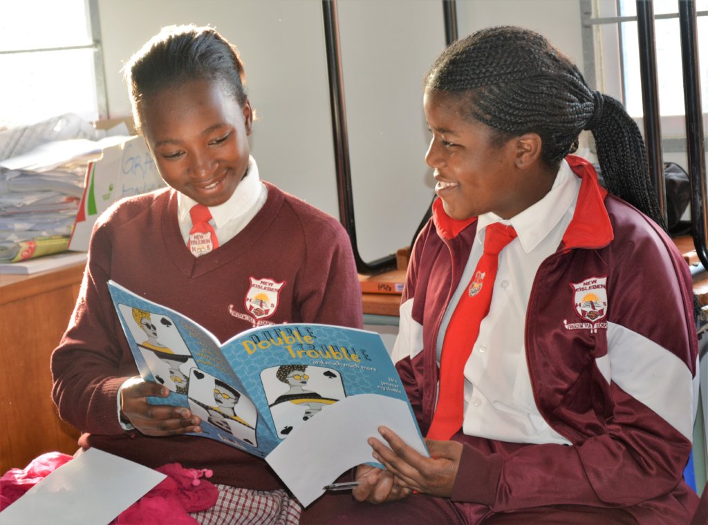 Learners engaged in book club reading session