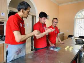 Mentor teaching new cooking skills