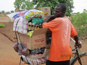 Shopkeeper takes Kit Yamoyo AidPods to his village