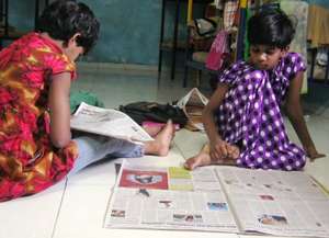 The girls enjoy reading the newspaper