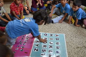 Girl learning alphabet in English