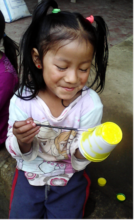 Roselyn, turning a styrofoam cup into an alphabet.