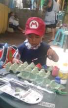 Cristopher making a worm with recyclable material