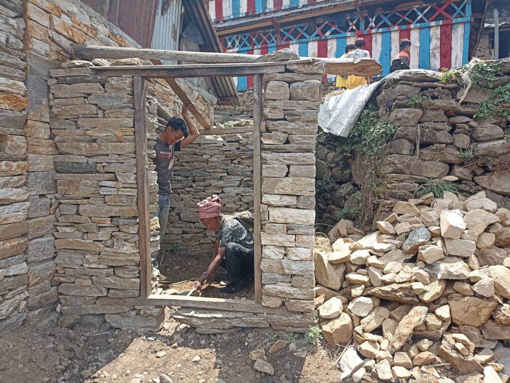 HHC supevisor measuring the size of the toilet