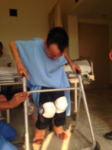 Chitra gradually stands with the help of a walker