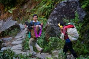 A patient is carried through the Himalayan trails
