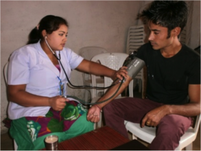 Taking a patient's blood pressure in Nepal.