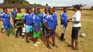 Coach Caroline and her team talk before the game