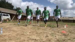 Members of an amputee team warm up