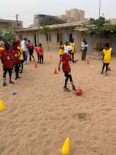 Girls do drills to learn basic soccer skills
