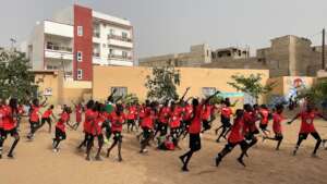 Girls run at the start of soccer at their school